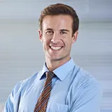 An Australia business man is smiling.