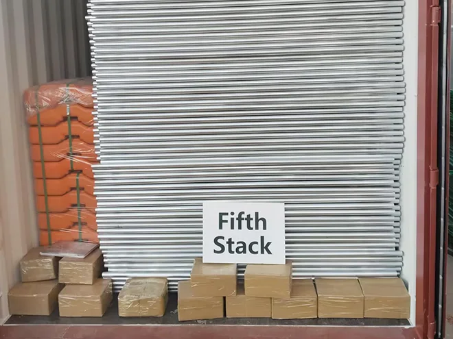 Several Australia temporary fencing panels, plastic feet and carton of accessories in the container.