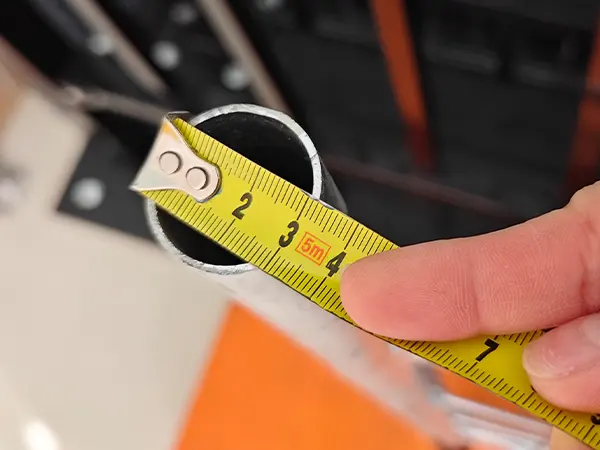 A QC worker is measuring the wire diameter of Australia Temporary Fencing.