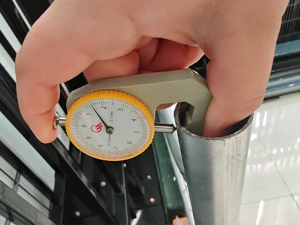 A QC worker is measuring the frame thickness of Australia Temporary Fencing.