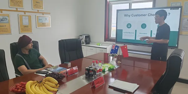 Australian wholesaler attends presentation in company meeting room.