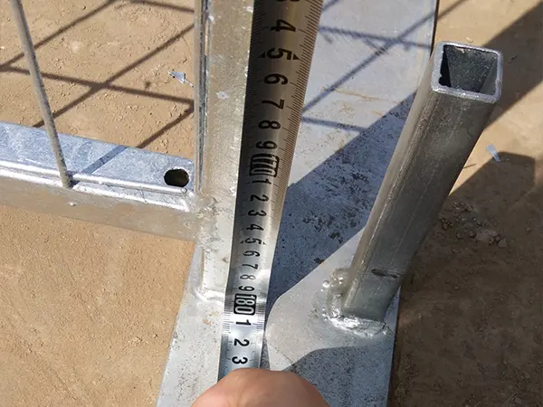 A QC worker is measuring the panel height of Canada temporary fence.