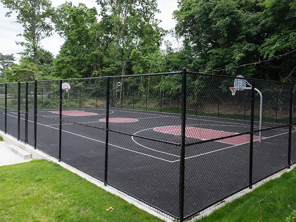 The chain link sports fences are installed in the basketball field.