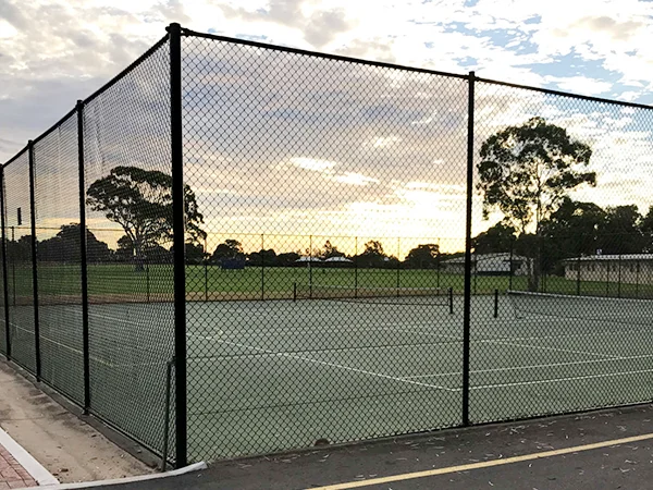 The chain link sports fences are installed in the tennis courts.