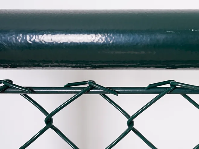 A rail detail of chain link sports fence.