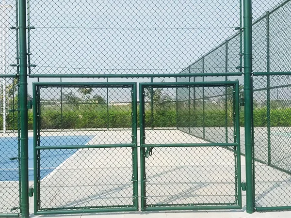 A double gate of chain link sports fence.