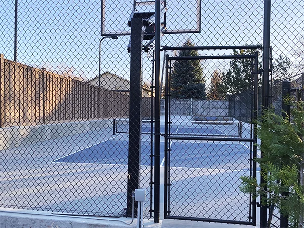 A single gate of chain link sports fence.