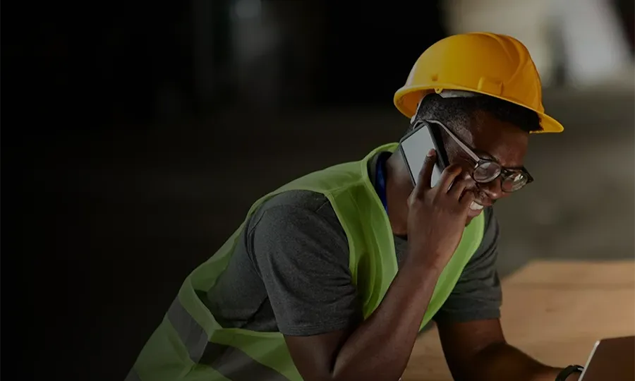 The contractor is chatting with others with mobile phone.