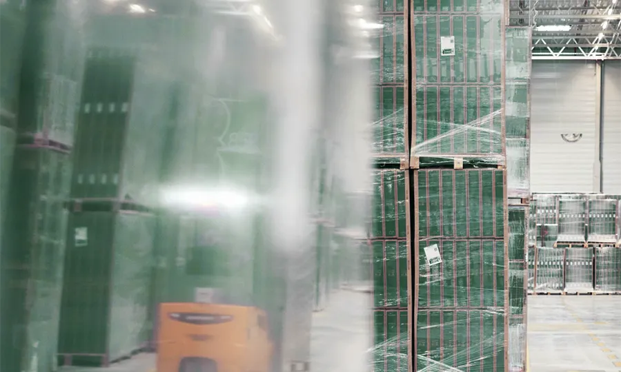 A distributor warehouse and several pallets of good in it.