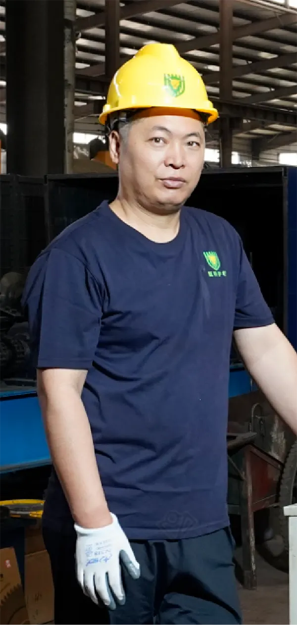 A worker is standing beside of the machine with smile.