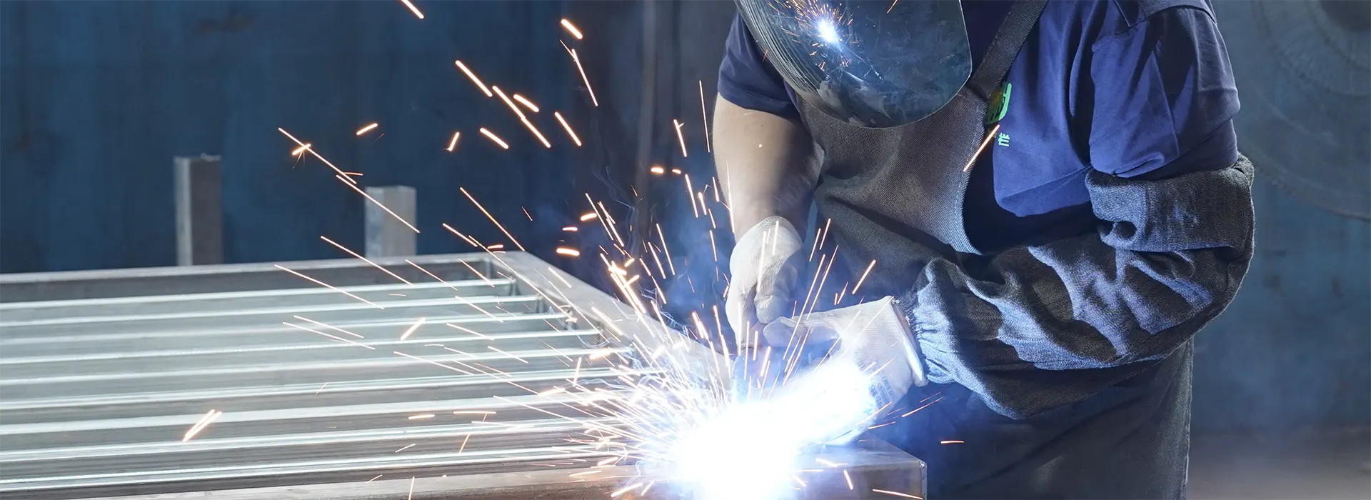 Workers standing in the workshop and with confident smile.