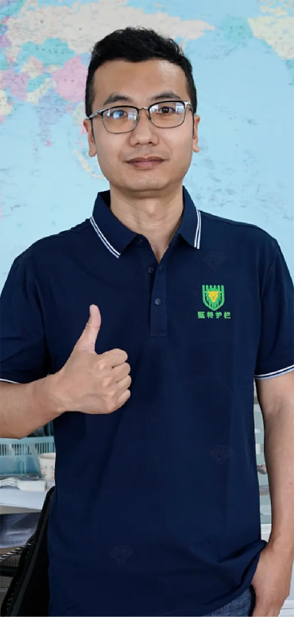 A technician is standing front of the world map with his thumb raising.