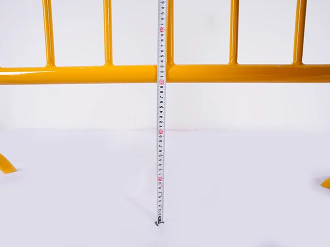 A QC worker is measuring the ground distance of crowd control barrier.