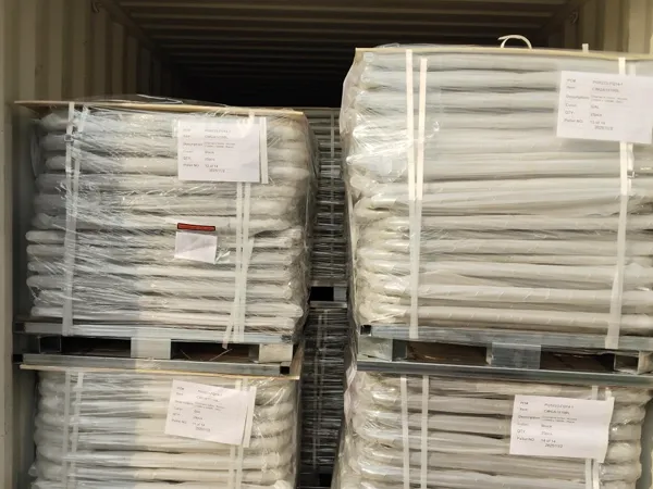 Two stacks of customized chain link gates, packaged with plastic film and straps, are stacked inside a container