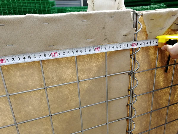 A QC worker is measuring the diaphragm width of defensive barriers.