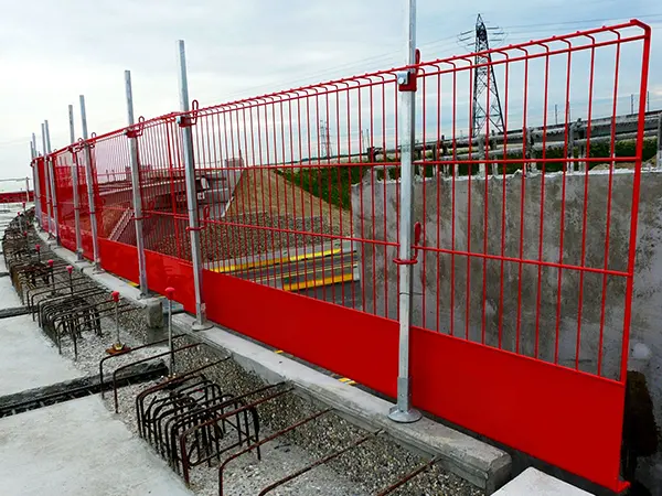 The red edge protection fences are installed at the top of building.