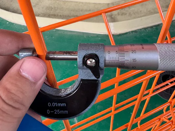 Measuring wire diameter of edge protection fence with micrometer.