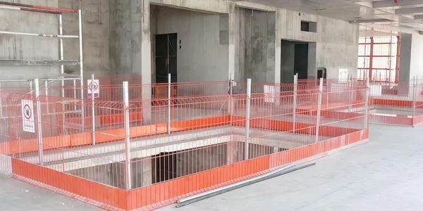 Edge protection fence installed for building construction pit.