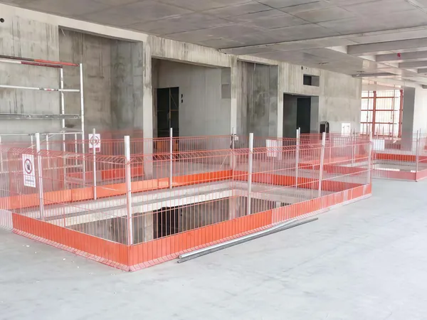 Edge protection fence installed for building construction pit.
