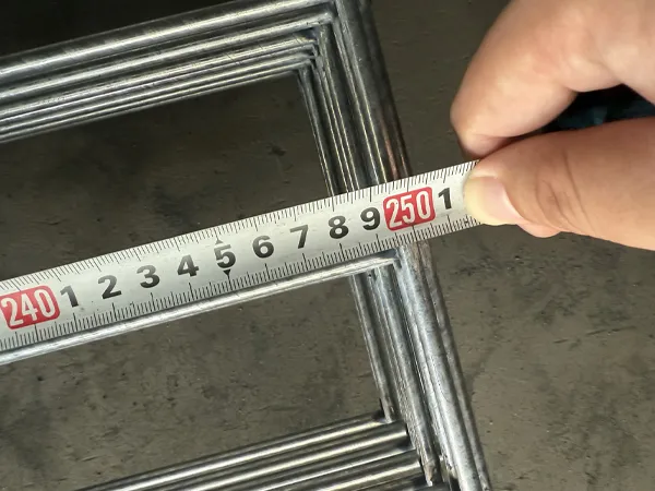 Worker measuring edge protection fence length