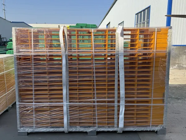 A batch of yellow edge protection fences packed with plastic film and straps, placed on the factory floor.