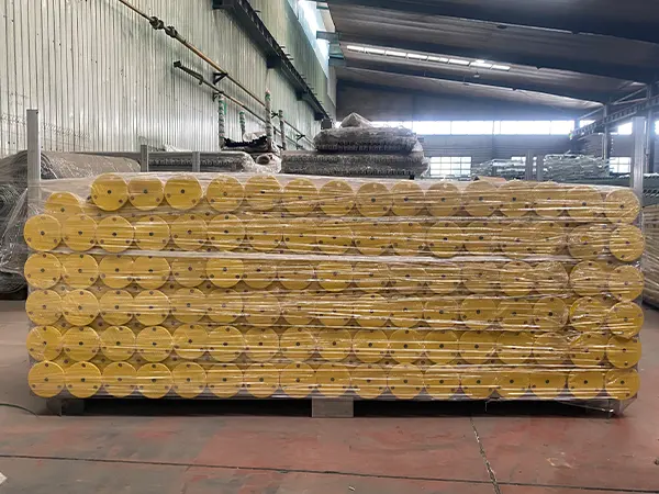 Several edge protection fence posts are packed with plastic films and metal pallets.