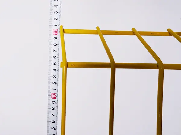 A QC worker is measuring the height of edge protection fence.