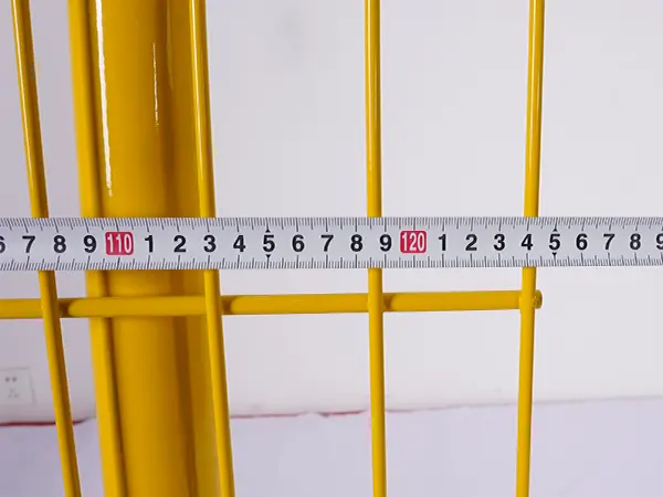 A QC worker is measuring the width of edge protection fence.