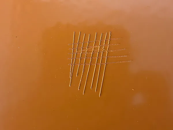 Surface scratch on coated edge protection fence panel.