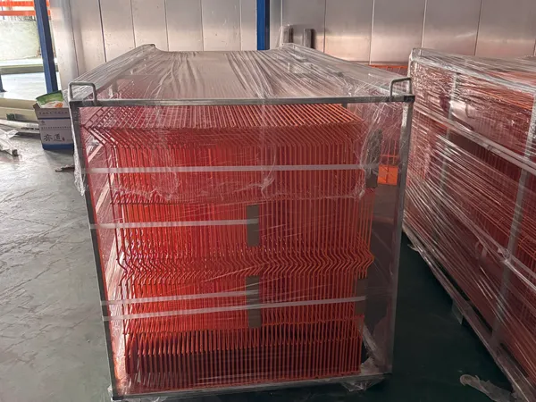 Packaged edge protection fence stacked inside factory workshop.