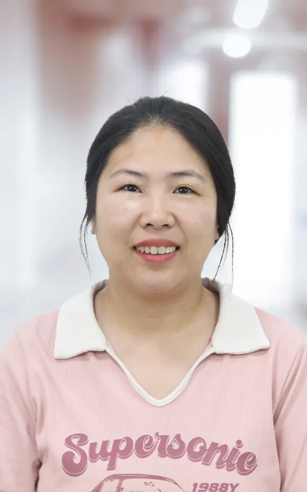 A woman employee is smiling.