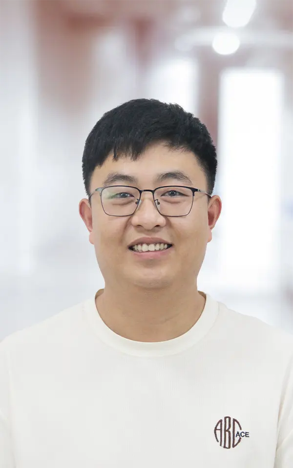 A man employee is smiling.