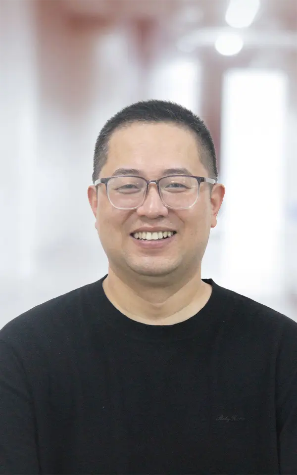 A man employee is smiling.