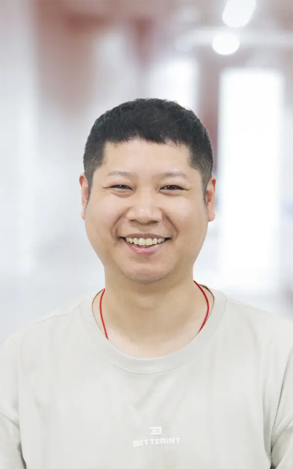 A man employee is smiling.