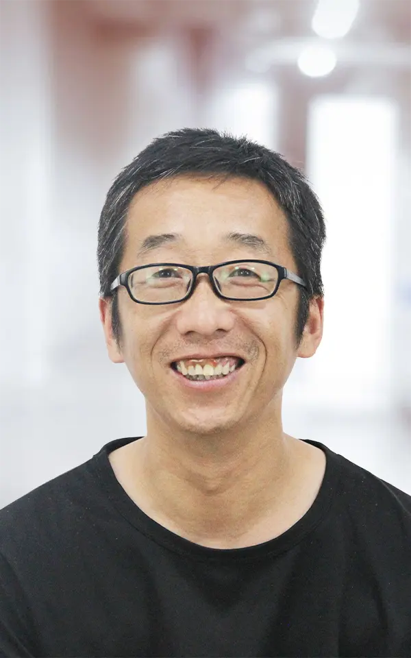 A man employee is smiling.