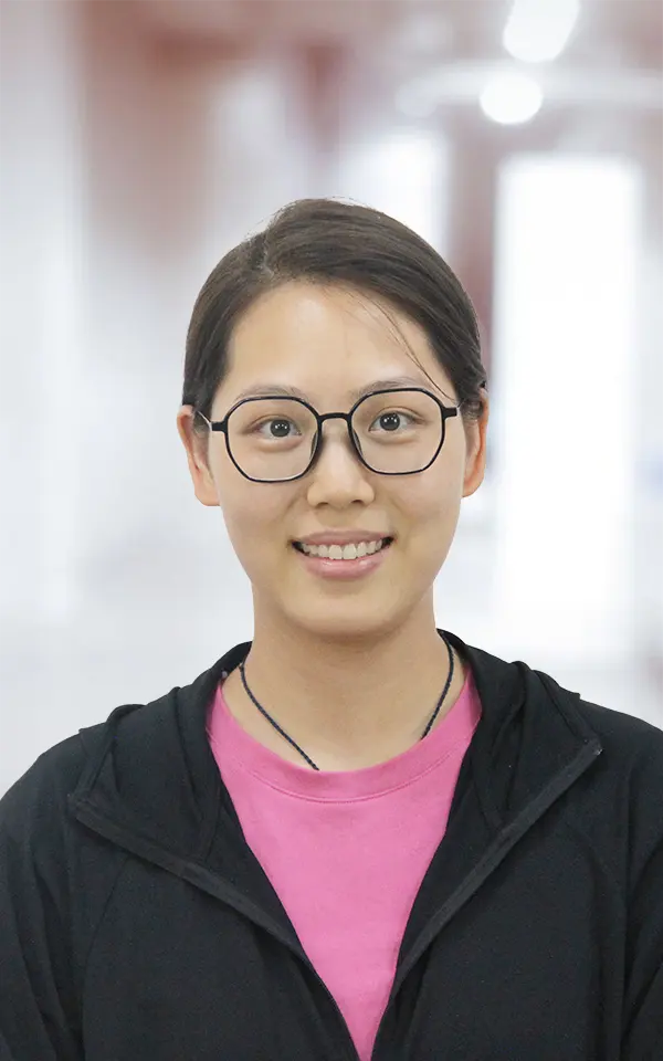 A woman employee is smiling.