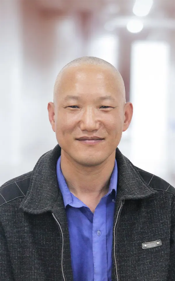 A man employee is smiling.