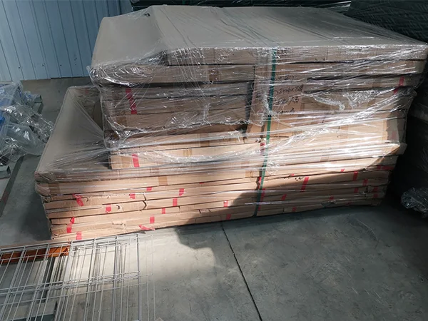Several pieces of fence gates with carton package on the ground.