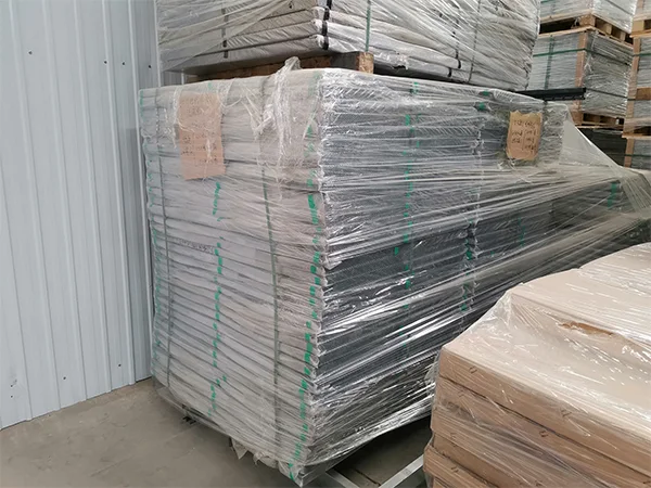 Two metal pallets of fence gates on the ground.