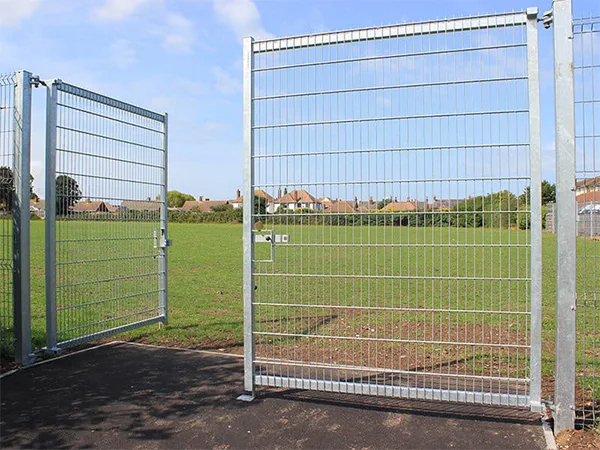 The double swing fence gate are installed at the grassland.