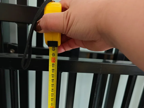 A QC worker is measuring the fence gate height of sliding fence gate.