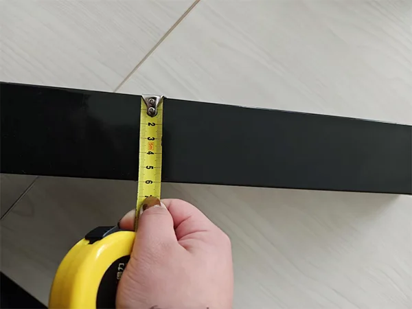 A QC worker is measuring the post size of sliding gate.