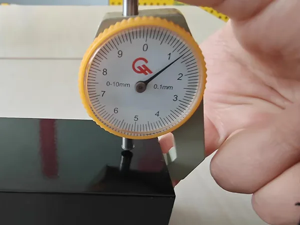 A QC worker is measuring the post thickness of sliding gate.