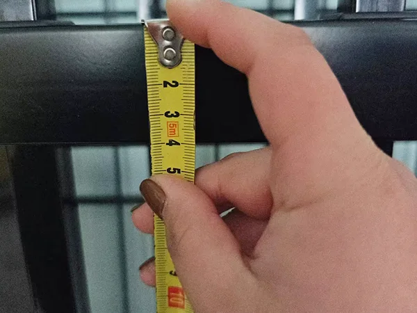A QC worker is measuring the rail size of sliding fence gate.