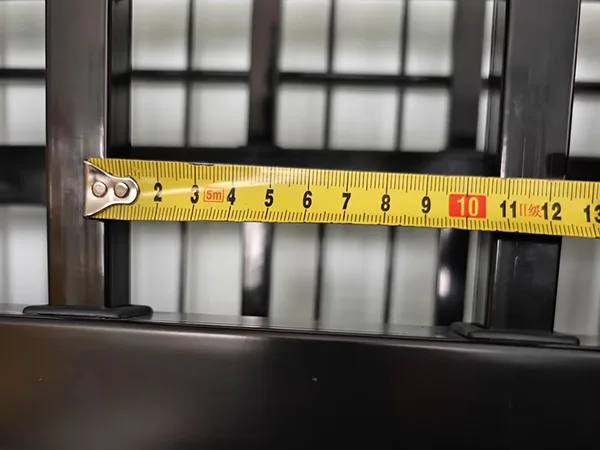 A QC worker is measuring the tubular spacing of sliding gate.