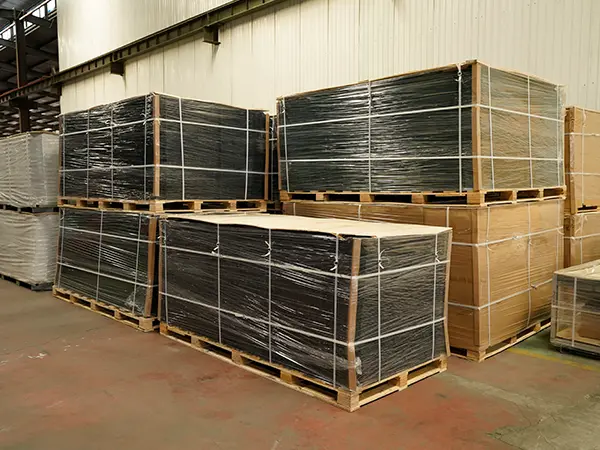 Several wooden pallets of wire mesh fences in the warehouse.