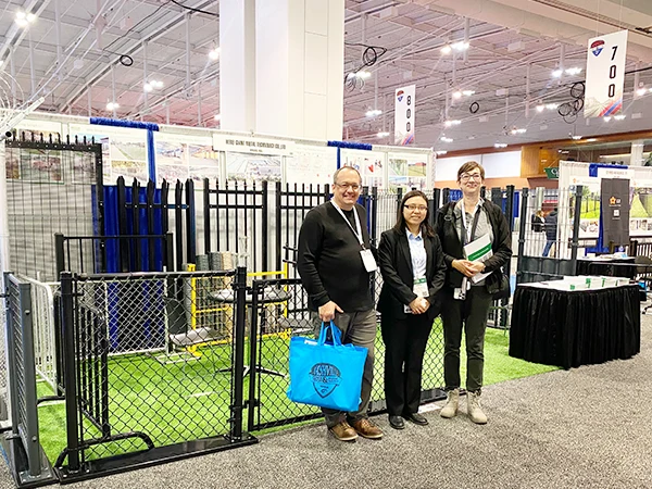 The sales representative takes photo with customers at the FENCETECH METALfab 2025.