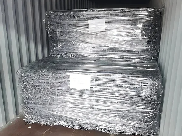 Several bundles of woven gabion retaining walls with plastic film wrapping in the container.