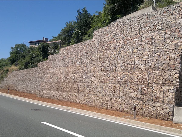 The woven gabion retaining walls are installed at the foot of the mountain.