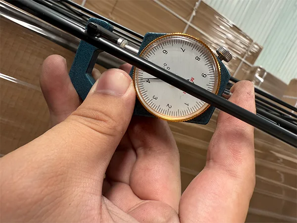 A QC worker is measuring the wire diameter of gabion wall